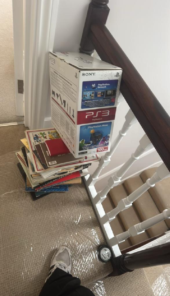 Rubbish removal in Walham Green before the clearance shows boxed parcels stacked near the stair railing