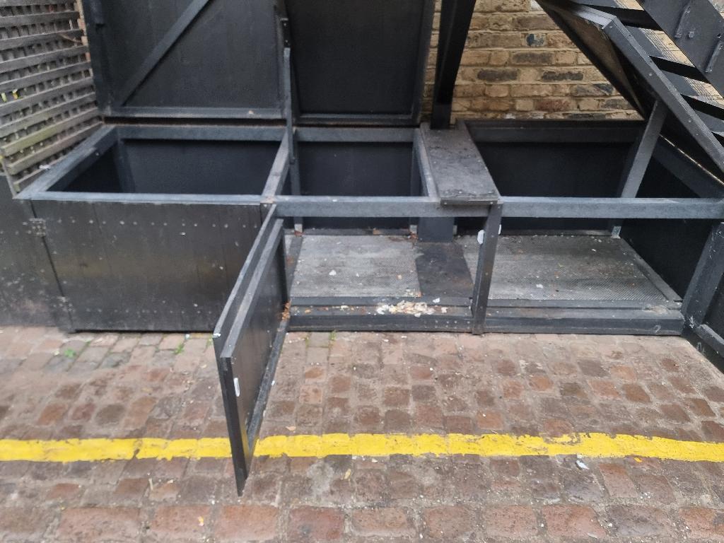 After furniture and bulky item removal in Colville, showing the bin bay compartments cleared of mixed waste and the ground cleaned and ready for use