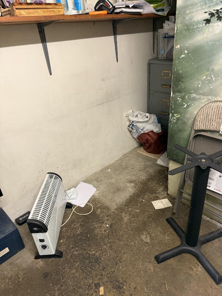 Household utility area clearance in Richmond after clearance showing open floor space and organised remaining items