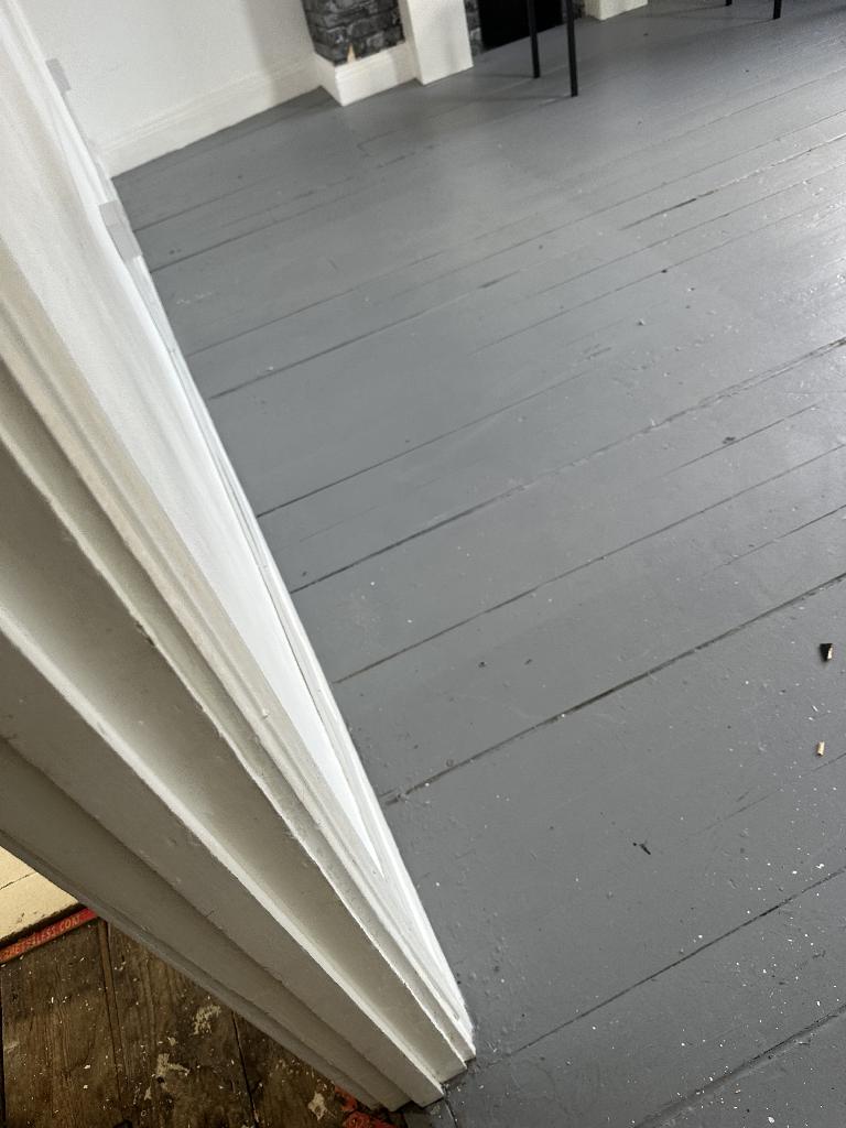 Furniture and bulky item removal in Clapham after service, showing cleared floor space near the doorway with debris removed