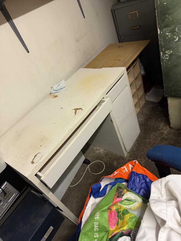 Household utility area clearance in Richmond before clearance showing bags and mixed waste beside kitchen cabinetry