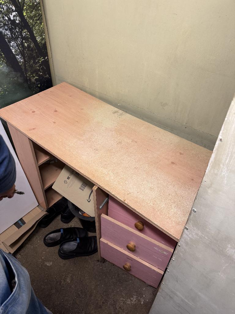 Household utility area clearance in Richmond before clearance showing clutter under a cabinet in a tight corner