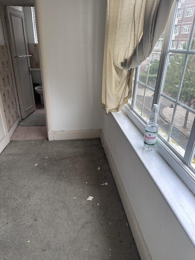 Flat clearance in Chelsea after waste removal, showing a cleared window-side space