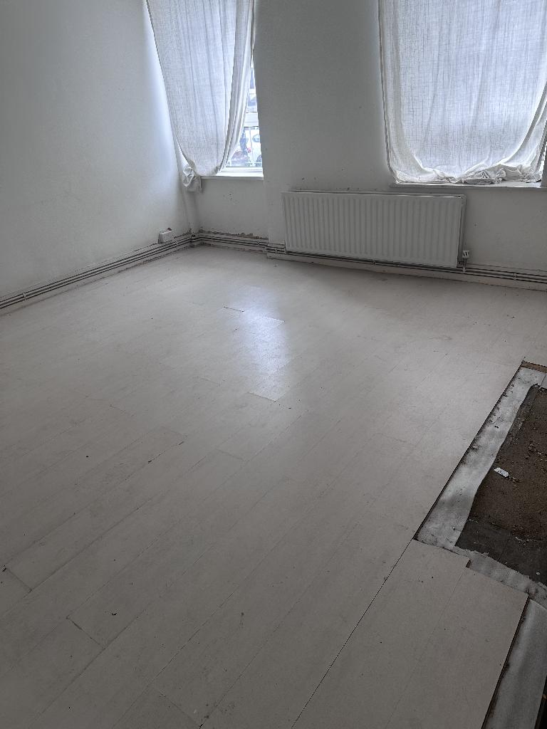 Flat clearance in Rotherhithe after completion, showing open tiled flooring and removed clutter