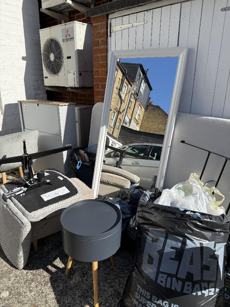 Furniture and household clearance in Twickenham before clearance showing mixed waste bags and furniture near door access