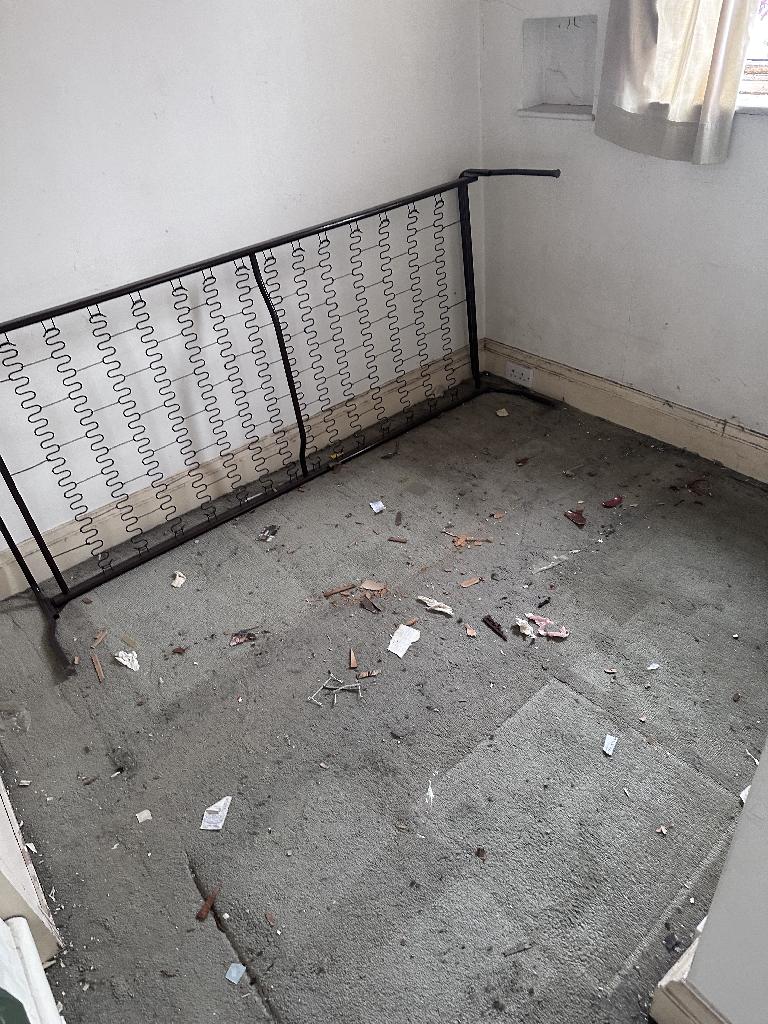 Flat clearance in Chelsea after waste removal, showing a cleared floor area