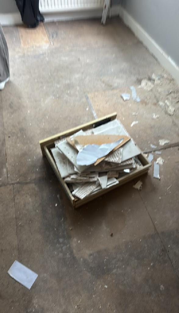 Rubbish removal in North Acton - before the clearance shows renovation debris and broken wood pieces on the floor