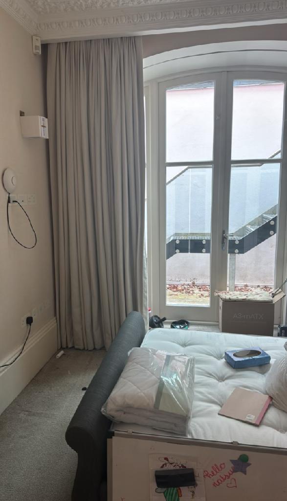 Furniture and bulky item removal in Hampstead Town after upholstery clearance leaving an open, tidy room near the window
