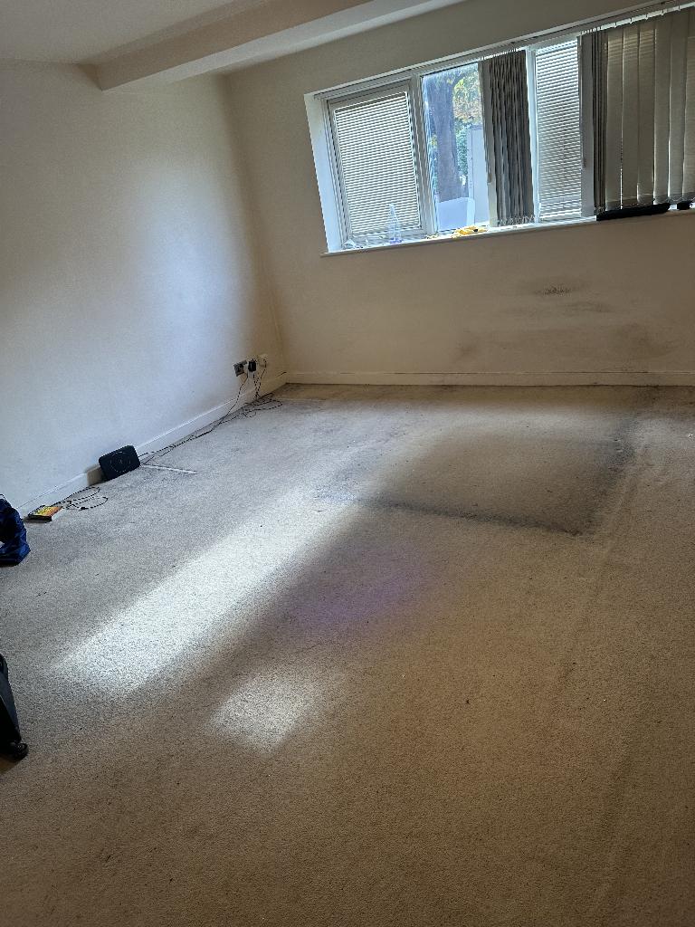 Furniture and bulky item removal in St Mark's & Seething Wells after the clearance, showing a clear open floor space in the ground-floor room