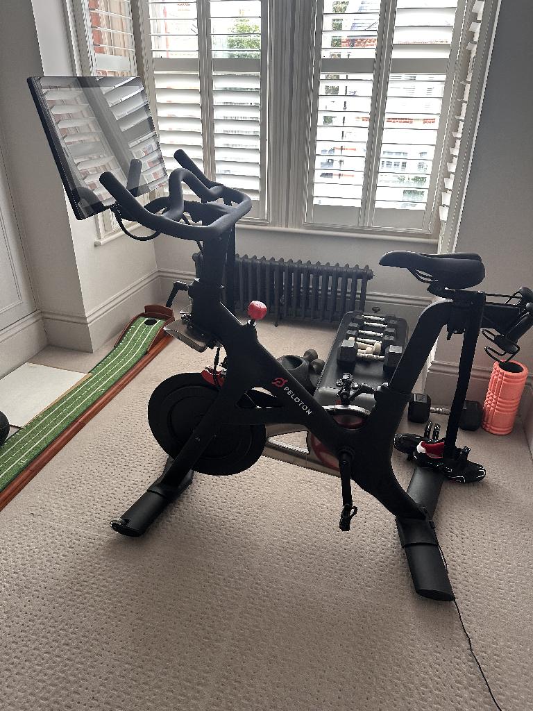 Home gym room clearance in Battersea before service, showing gym equipment and mats grouped near the window