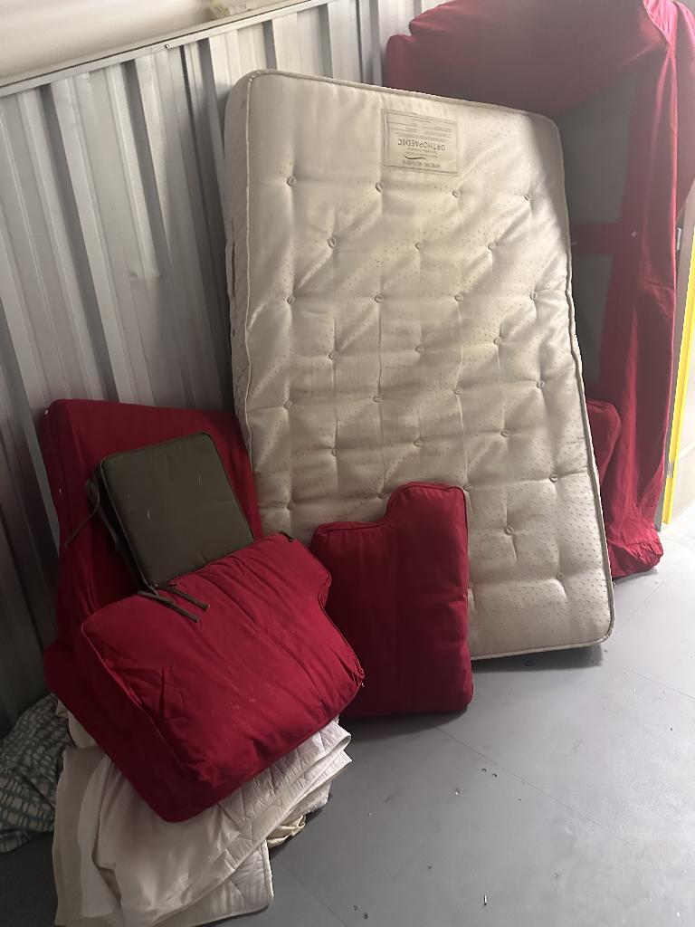 Storage unit clearance in West Finchley at a storage locker showing a double mattress and sofa on the right side