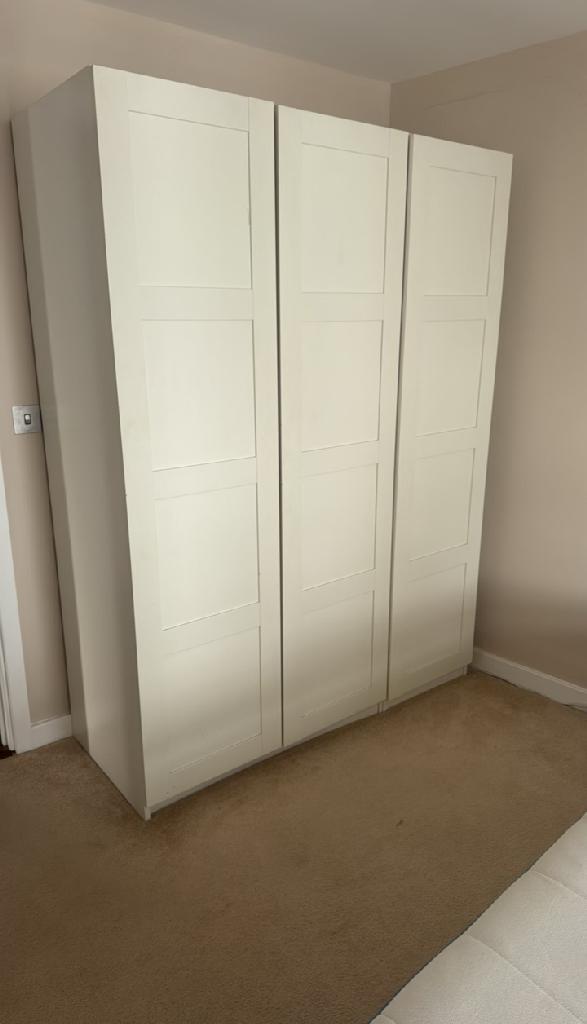 Household furniture clearance in Dalston before clearance, showing bulky wardrobe units in a room with limited open floor space