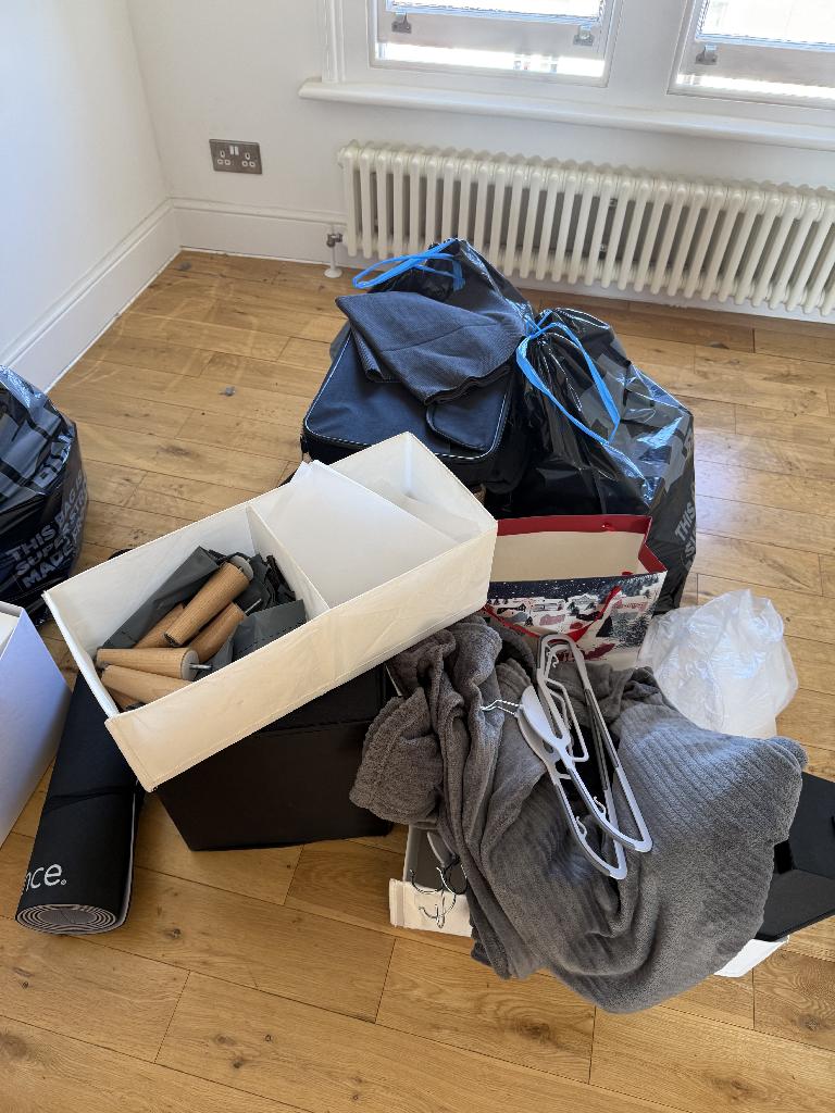 Furniture and household clearance in Twickenham after clearance leaving open floor space with grouped bags near radiator