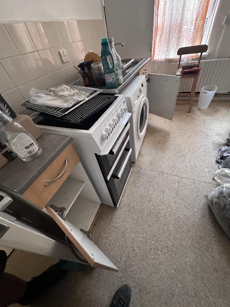 Rubbish removal in Rotherhithe before clearance shows a cooker area with items and waste around it