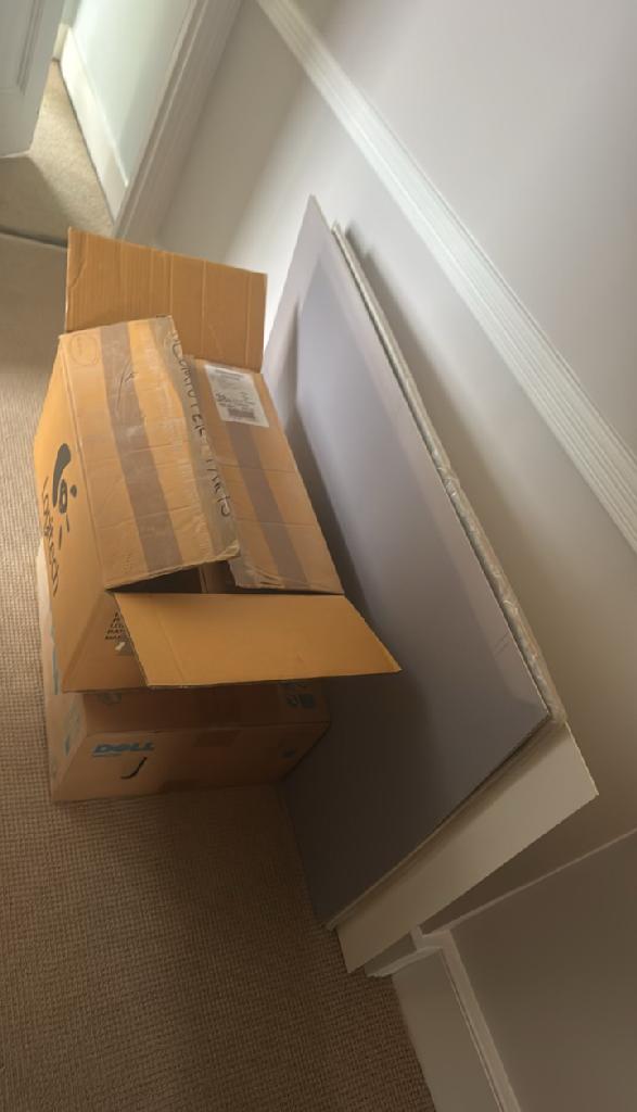 Rubbish removal in Walham Green before the clearance shows stacked cardboard boxes near an interior doorway