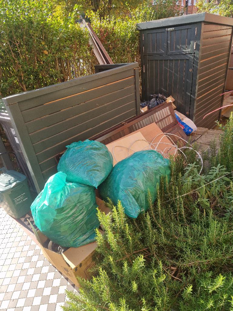 Rubbish removal in Friern Barnet: before photo showing bags and bulky waste at the garden boundary