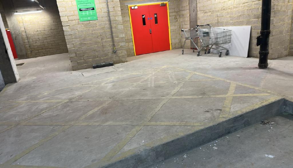 Household storage area clearance in Ilford after clearance, showing the storage area with open, cleaned floor and removed cardboard waste