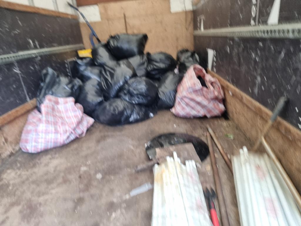 After clothing and household item clearance in Bermondsey: bagged old clothing and footwear gathered for proper disposal