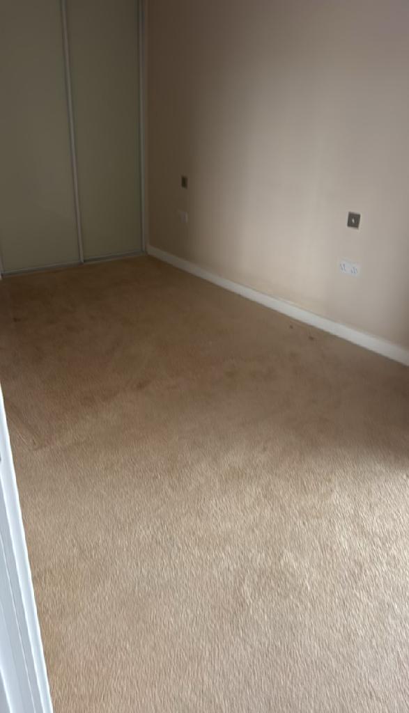 Household furniture clearance in Dalston after clearance, showing an empty carpeted room ready for use