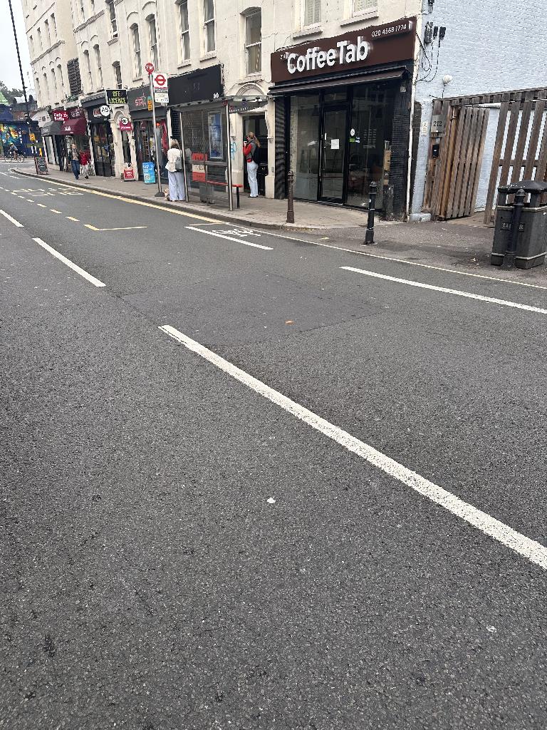 Property frontage in Walham Green before clearance, showing pavement area near boundary and shop frontage