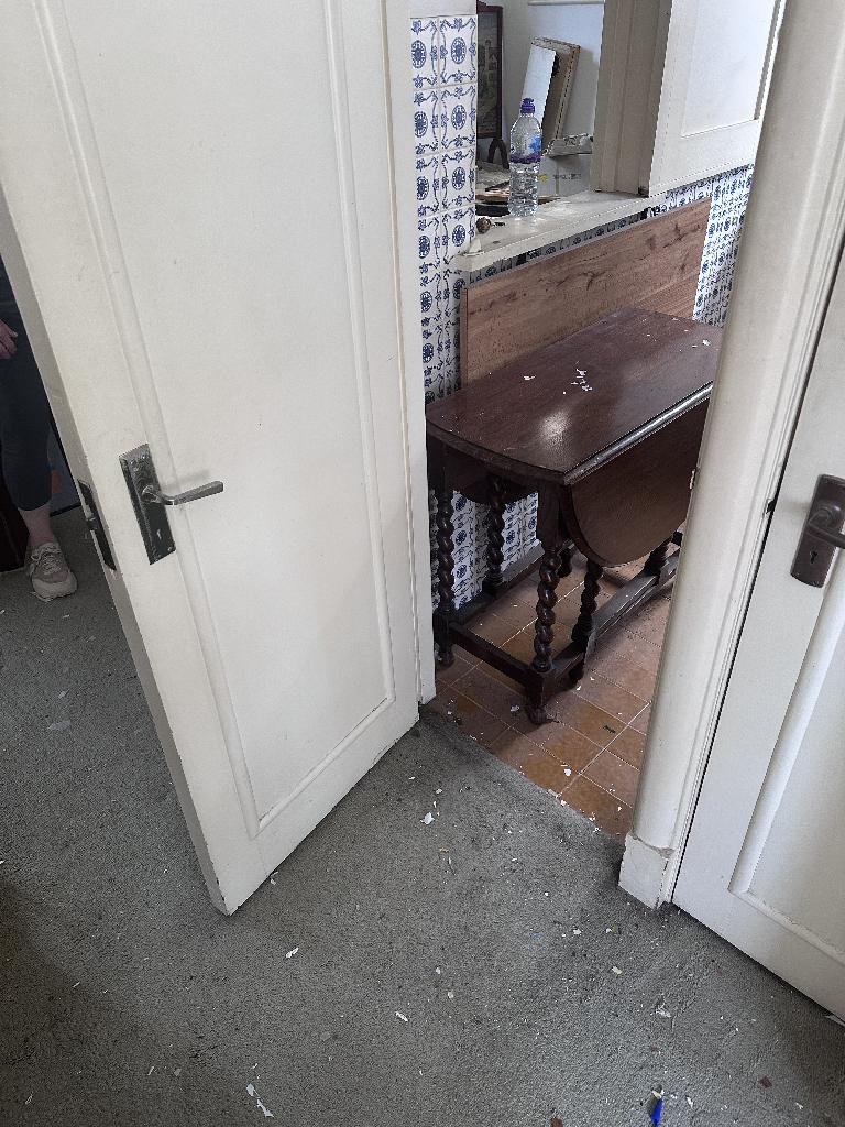 Household clutter clearance in Chelsea after service, showing a cleared doorway and cabinet area