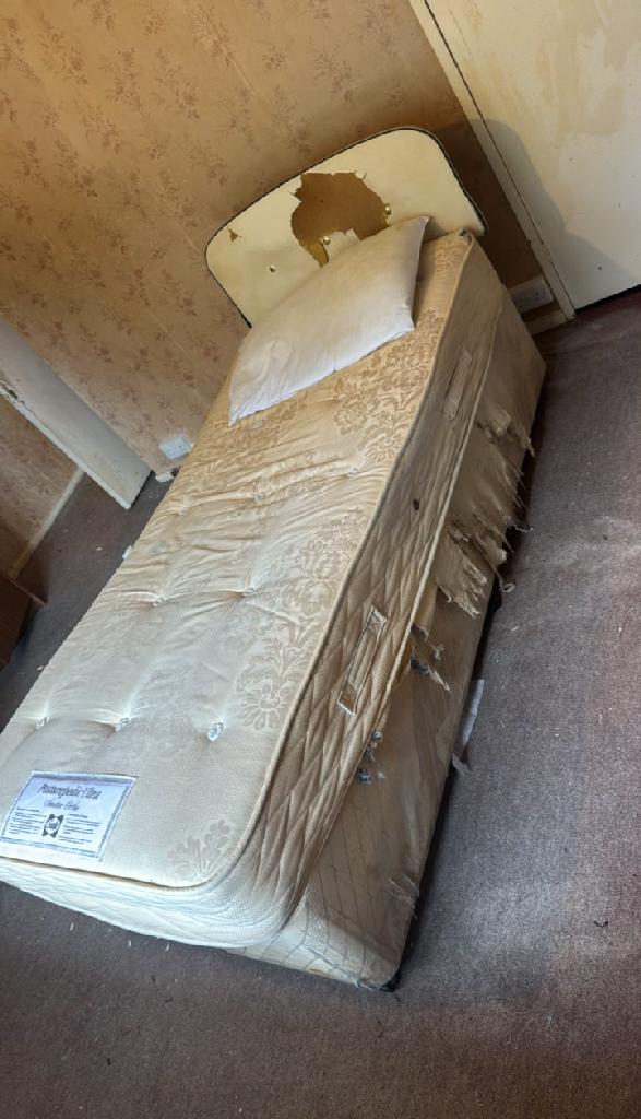Bed and bedding clutter in Wembley Park before household furniture clearance