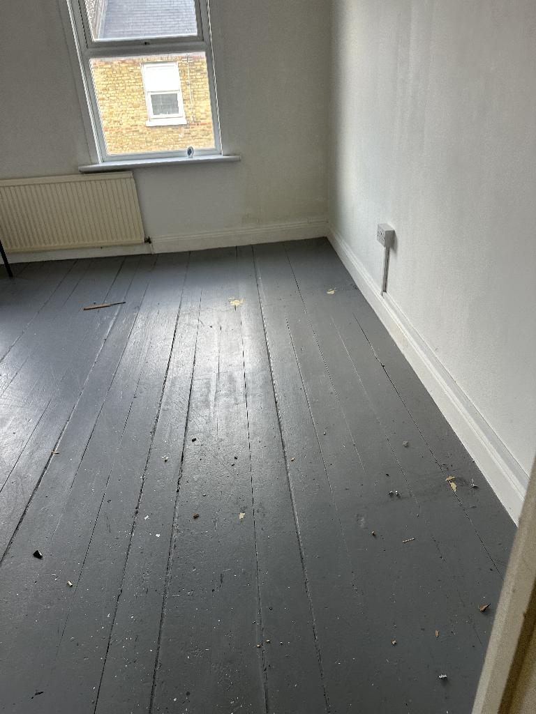 Internal household clearance in Clapham after service, showing a cleared empty room floor near a window
