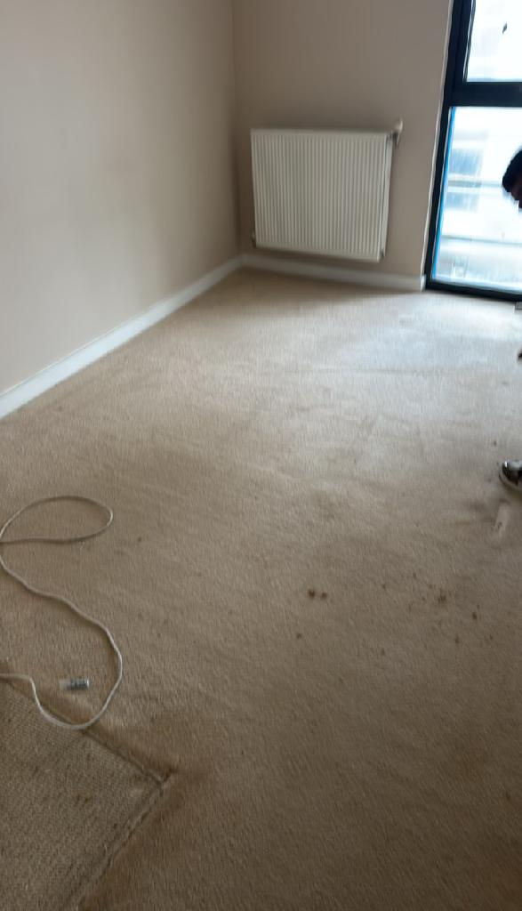 Household furniture clearance in Dalston after clearance, showing the bedroom open and clean with radiator and window visible