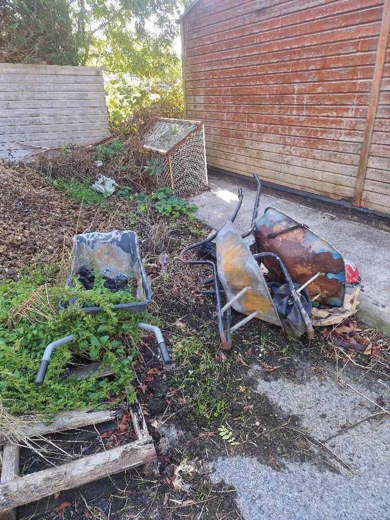 Garden and yard clearance in Putney before the clearance, showing garden corner waste near the fence line
