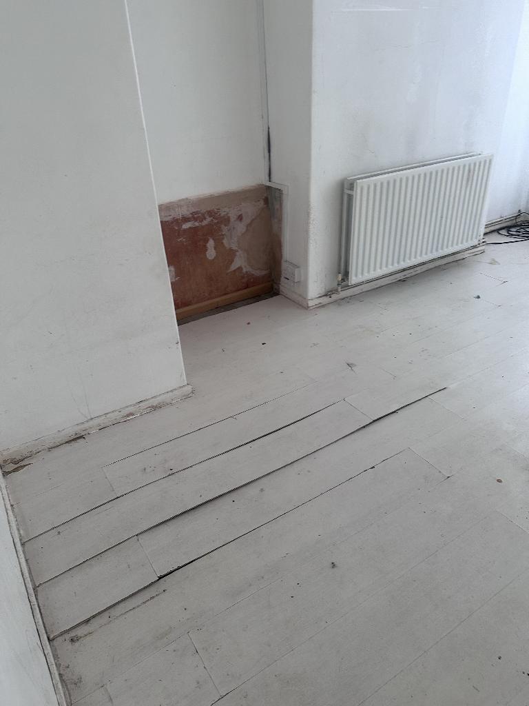 Flat clearance in Rotherhithe after completion, showing cleared floors and removed clutter from the corner area