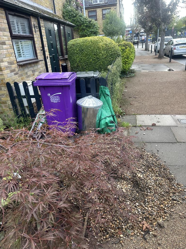 Builders and renovation waste clearance in Whitechapel after clearance showing cleared ground area and bins positioned neatly where waste was removed