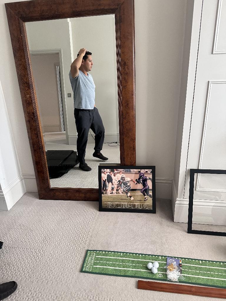 Home gym room clearance in Battersea before service, showing loose mat strips and items on the floor near a mirror