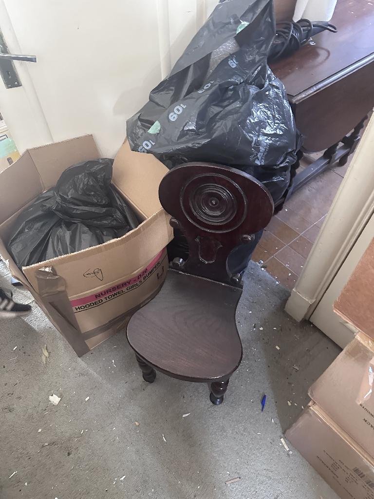 Household clutter clearance in Chelsea before service, showing packed boxes and clutter