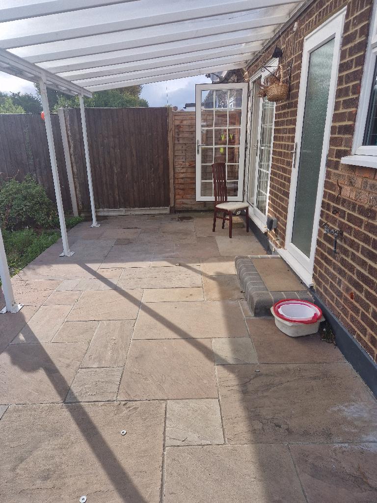After patio and household waste clearance in Romford, showing a cleared patio area with open, paved access restored