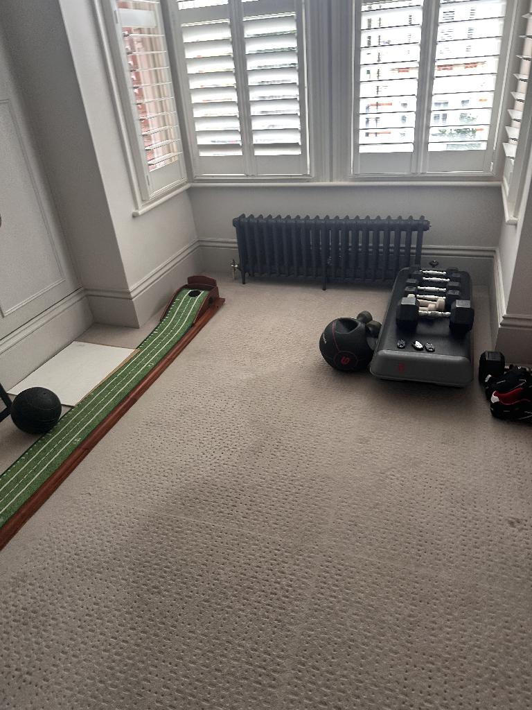 Home gym room clearance in Battersea after service, showing a cleared carpet corner with improved open space
