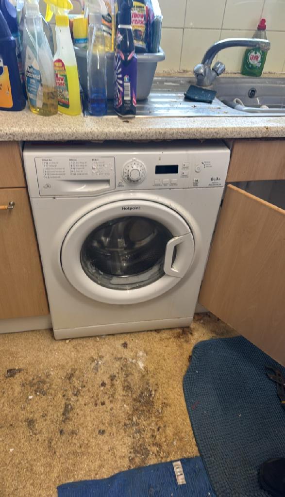 Kitchen floor debris and laundry items in Wembley Park before household furniture clearance