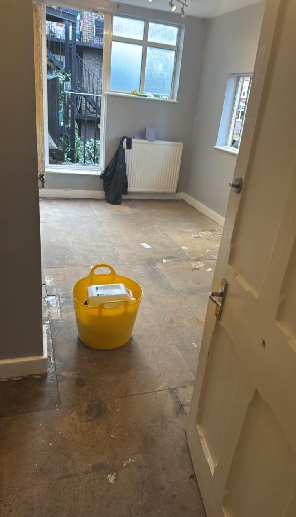 Flat clearance in North Acton - after the clearance shows a much clearer room floor with bin staged