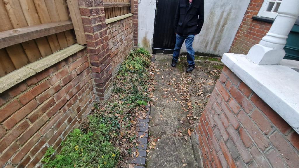 Front garden after clearance in Pinner South, garden walkway area left clean