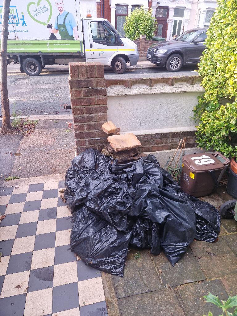 Front garden clearance on Hoe Street - before, showing black refuse bags piled near the front boundary and paving