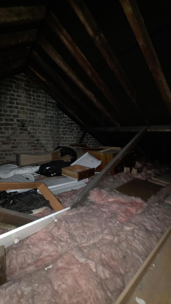 Rubbish removal in Stratford before the loft clearance, showing stored items across the loft floor and near the access route
