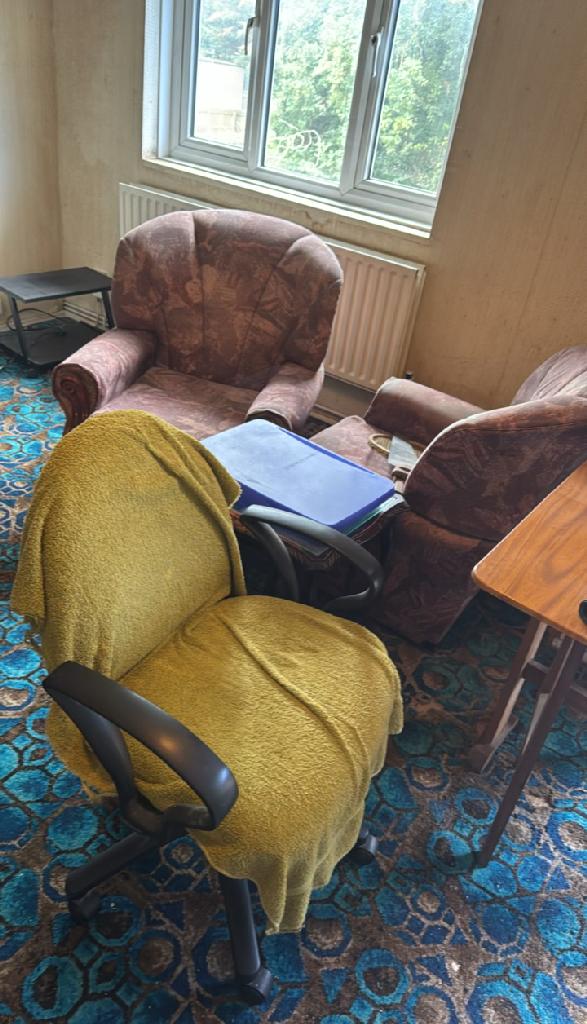 Living room seating clutter near window in Wembley Park before rubbish removal