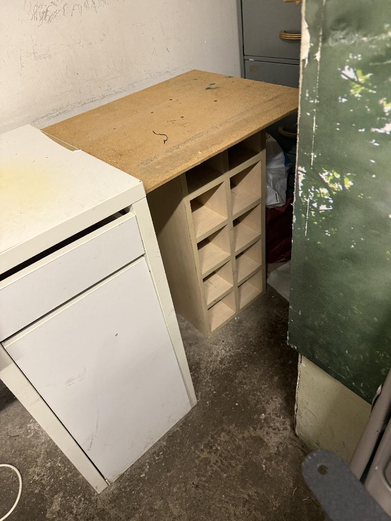 Household utility area clearance in Richmond before clearance showing waste near a cabinet corner and floor clutter
