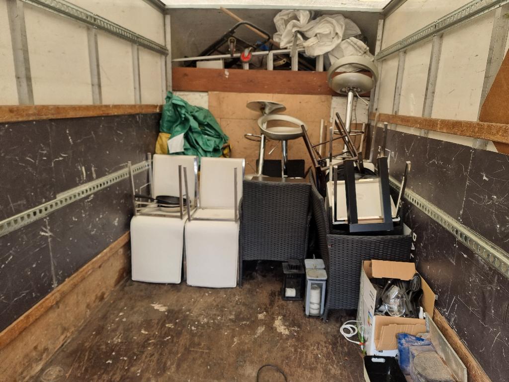 Internal property clearance in Shoreditch before service, showing a cluttered internal room with items stacked along the walls and limited usable floor space