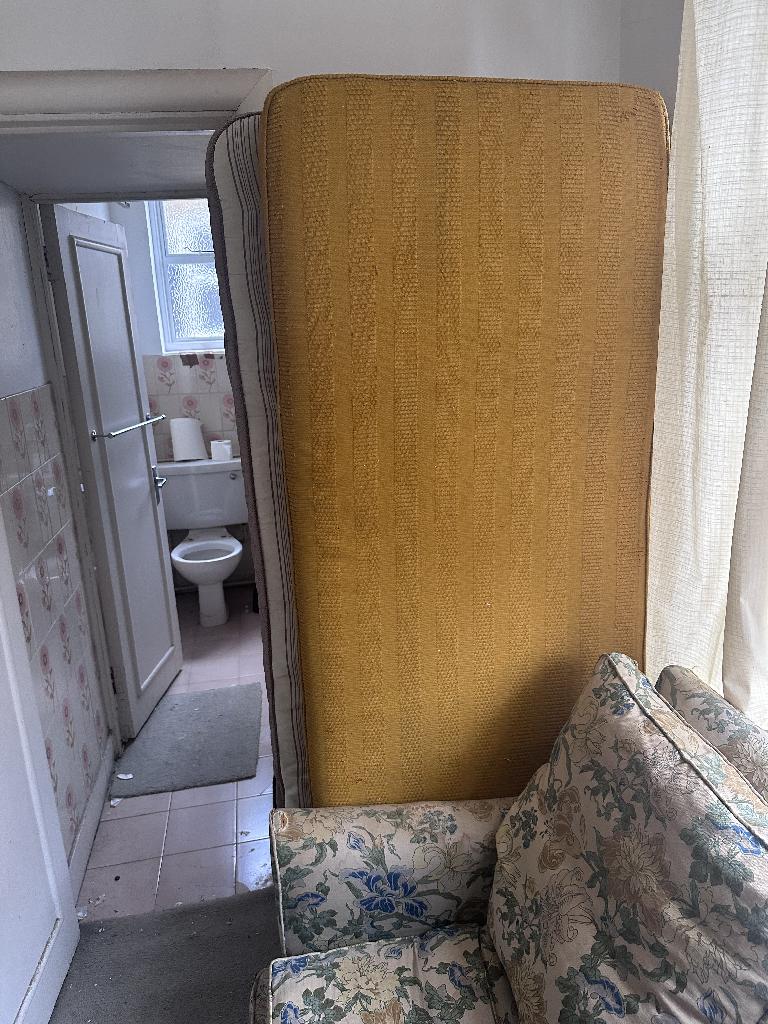 Rubbish removal in Brompton & Hans Town showing upholstered furniture near cluttered space before clearance