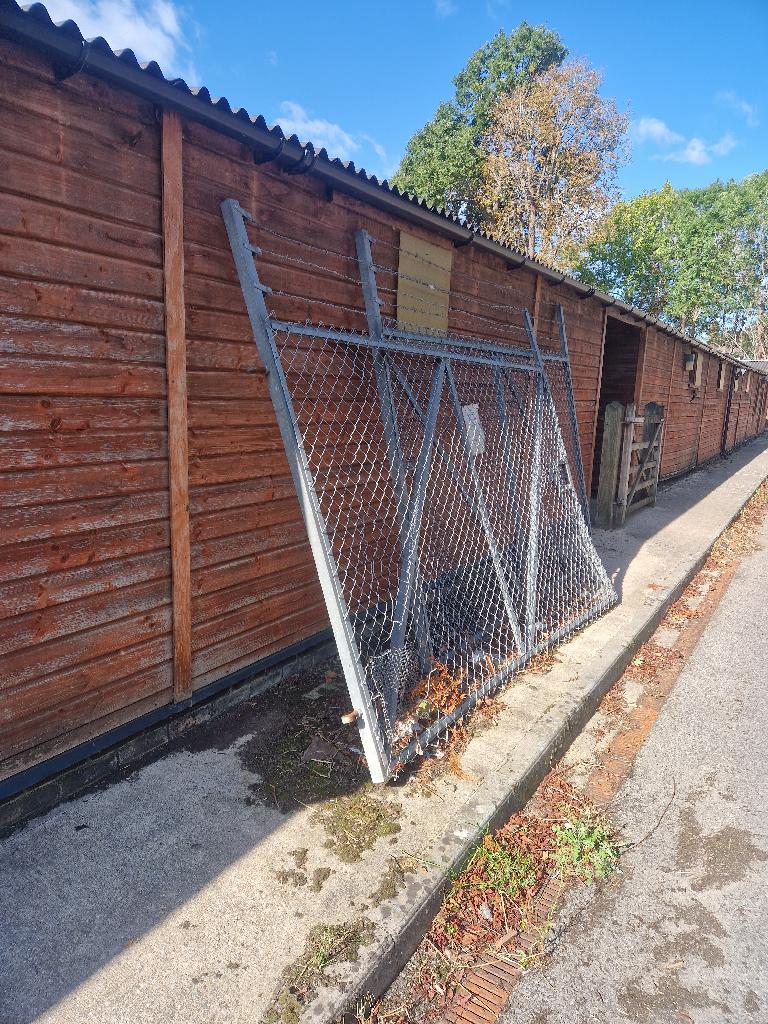Garden and yard clearance in Putney before the clearance, showing the side yard boundary and scattered debris