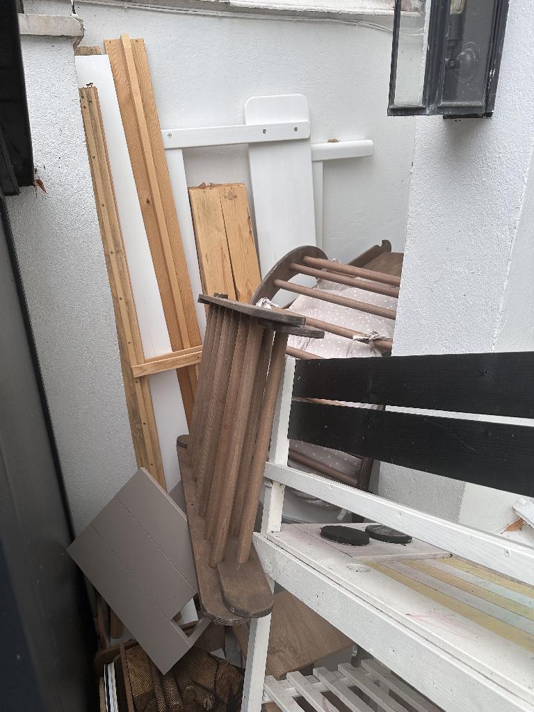 Household furniture clearance in Campden - before, showing stacked wooden boards and obstructed corner area