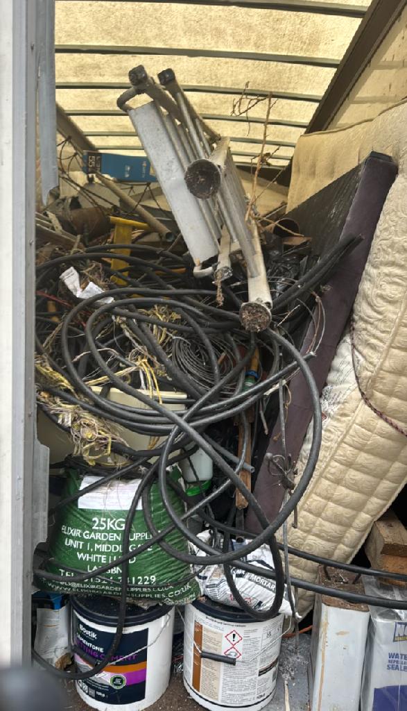 Flat clearance in Walham Green after the clearance, showing an organized storage bay with hoses and materials grouped neatly